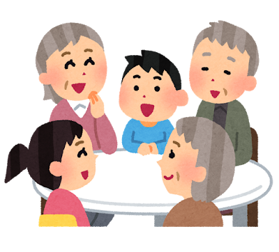 テーブルを囲んで笑顔で会話するお年寄りと子どもたち